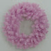 A 24" Pink Artificial Pine Wreath (82295-PK), crafted from light pink artificial pine branches and arranged in a perfect circle against a plain light background, adds a unique and stylish touch to your seasonal décor.