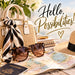 Flat metal sign with Hello Possibilities lettering, cream handbag, black and ivory scarf, sunglasses, passport, travel map, and straw hat, TTE-895.