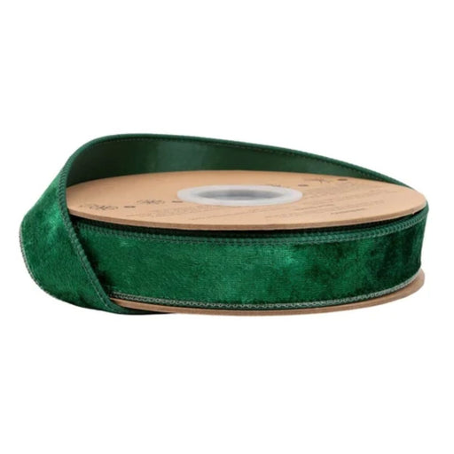 The Heritage Hunter Velvet with Hunter Back Wired Ribbon (1 Inch x 10 Yards | 7005W-589-25E) features rich hunter green velvet with a lustrous finish, partially unrolled on its brown cardboard reel and set against a white background—ideal for Christmas decorating.