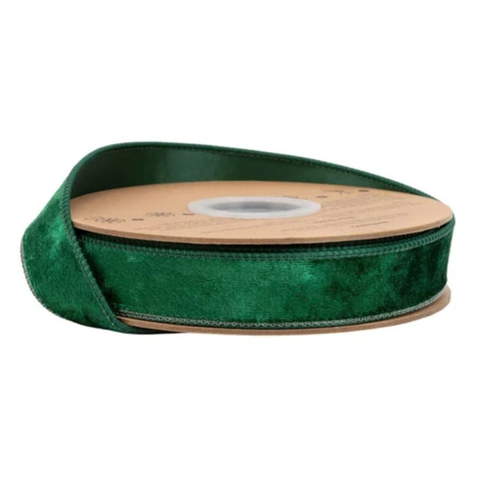 The Heritage Hunter Velvet with Hunter Back Wired Ribbon (1 Inch x 10 Yards | 7005W-589-25E) features rich hunter green velvet with a lustrous finish, partially unrolled on its brown cardboard reel and set against a white background—ideal for Christmas decorating.