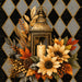 10 x 10 metal fall wreath sign featuring a lantern with candle, golden sunflowers, autumn leaves, pinecones, and berries on a black and gold harlequin background. Exclusive Trendy Tree Design for deco mesh wreaths, grapevine wreaths, or framing. SKU TTE-487.