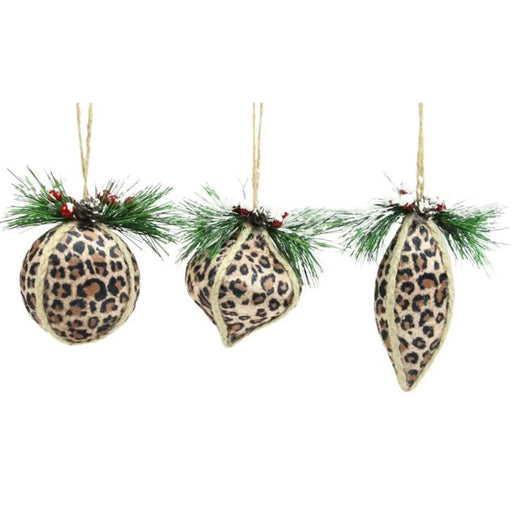 Three leopard-print Christmas ornaments hanging from jute twine with green pine branches and small red berries, shown on a plain white background.