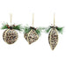 Three leopard-print Christmas ornaments hanging from jute twine with green pine branches and small red berries, shown on a plain white background.