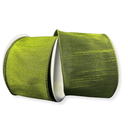 A spool of 2.5" Moss Green Faux Dupioni Wired Ribbon (72434-40-08) is partially unspooled, with both ends curling outward against a white background. This ribbon features a silk-like sheen and a soft texture that enhances its rich moss green hue.