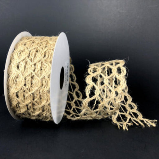 A spool of 1.5" Natural Hex Open Weave Wired Ribbon (47386-09-15) in beige rests on a black surface, with part of its natural jute netted ribbon unrolled and extending outward—ideal for bringing a rustic farmhouse décor accent to any project.