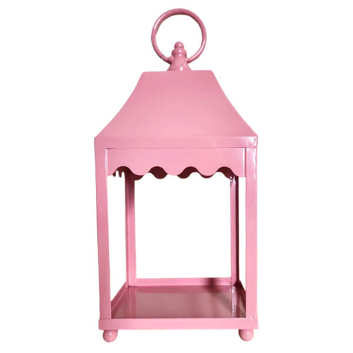 The 13.5" Pale Pink Scalloped Lantern (4559176) sits on a wooden surface against a plain white wall.
