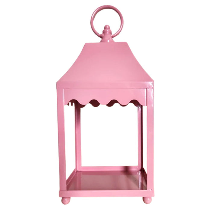 The 13.5" Pale Pink Scalloped Lantern (4559176) sits on a wooden surface against a plain white wall.