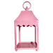 The 13.5" Pale Pink Scalloped Lantern (4559176) sits on a wooden surface against a plain white wall.