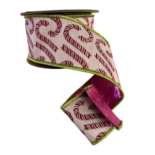 A spool of Pink Jacquard Candy Cane Wired Ribbon with Pink Dupioni Back, measuring 2.5 inches by 5 yards, features charming candy cane patterns on a light background and is perfect for adding festive flair to your Christmas wreaths.