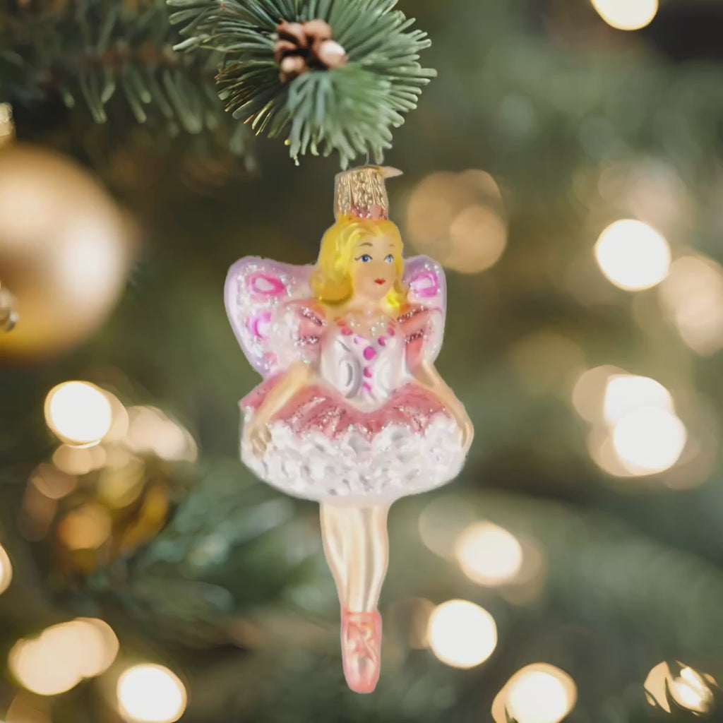 The Sugar Plum Fairy Christmas 10111 Ornament by Old World Christmas is a glass ornament with pink and purple glittery wings, a white and pink dress, ballet shoes, and classic charm—beautifully detailed 