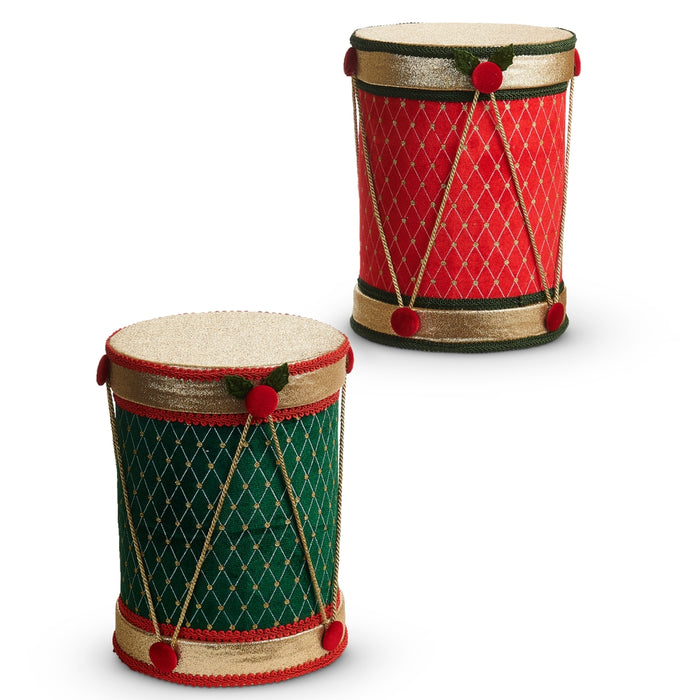 Add festive charm to your Christmas decor with the 12″ Red or Green Velvet Christmas Drum (RAZ 4603582). Available in red or green velvet, each drum features elegant gold trim, bright red pom-poms, and a crisscrossed gold string pattern. Inspired by the classic RAZ Imports design, these decorative accents stand upright on a white background and bring timeless holiday cheer to any space.