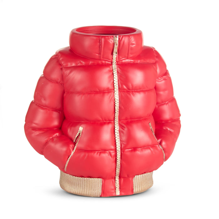 A 10″ Red Puffer Ski Jacket Vase (RAZ 4610524), inspired by the iconic quilted jacket with gold zippers and trim, stands upright from the Après Ski Collection. Designed with visible sleeves and pockets yet hollow inside, this striking piece cleverly blends functional artistry with winter charm—perfect for seasonal floral arrangements or as a statement décor accent.
