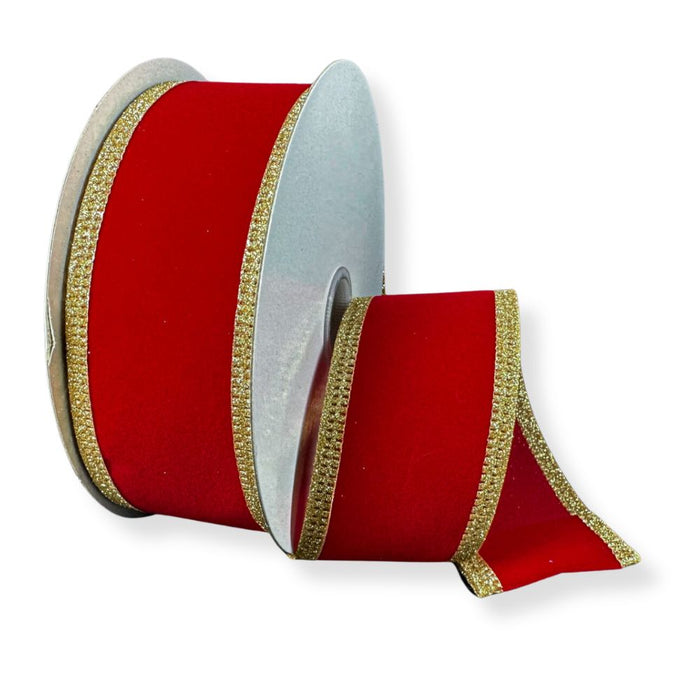A partially unrolled 1.5" Red Velvet Ribbon with Gold Glitter Edge (76561-09-15) showcases its vibrant hue and shimmering trim, making it the perfect choice for Christmas décor. The rich red color and sparkling edge stand out beautifully against the plain white background.