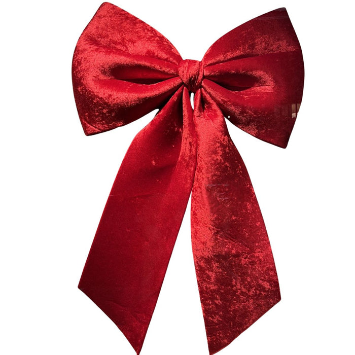 Oversized red velvet 3D Christmas hanging bow measuring 32 by 47 inches with long tails.