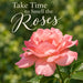 Flat metal sign with Take Time to Smell the Roses lettering above a large pink rose against a soft green garden background, TTE-896.
