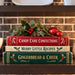 Vintage Christmas cookbook stack with candy canes, holly, red ornaments and holiday greenery