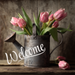 10-inch metal sign featuring pink tulips in a vintage watering can with the word “Welcome” in white script, set against a rustic wooden background.