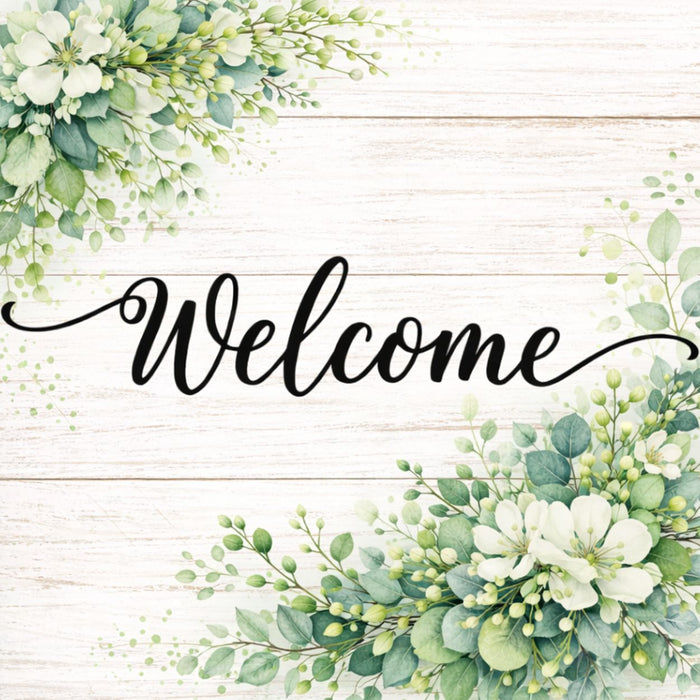Welcome metal wreath sign with printed whitewashed plank background, green foliage and white flowers.
