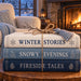 Cozy winter book stack metal sign with blue and cream books, snowy window, and glowing fireplace TTE-822