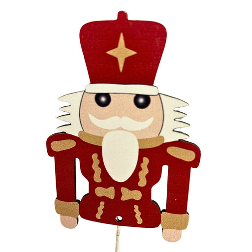 26-inch Christmas spray with three red and gold wooden nutcracker figures on stems.