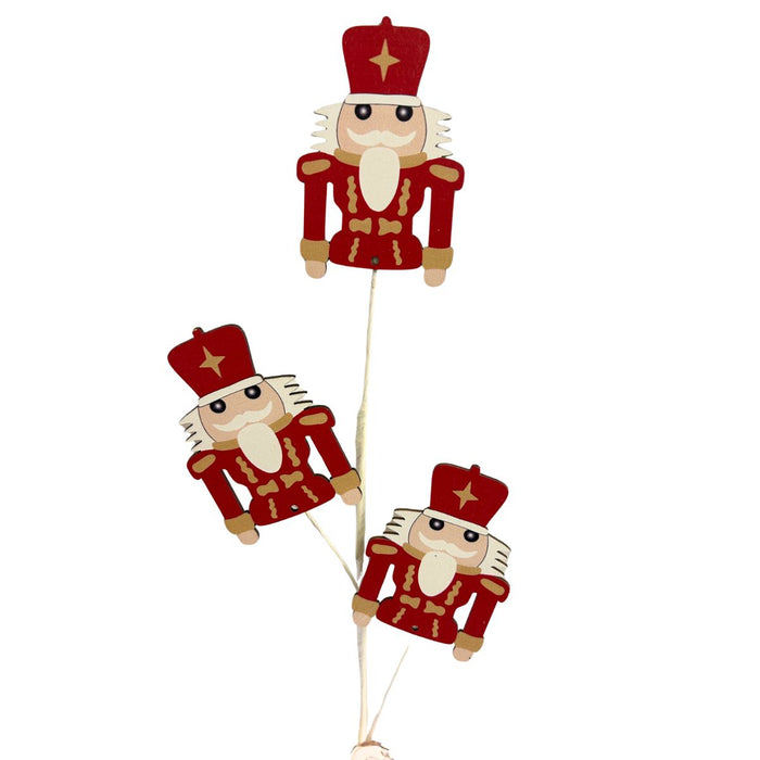 26-inch Christmas spray with three red and gold wooden nutcracker figures on stems.