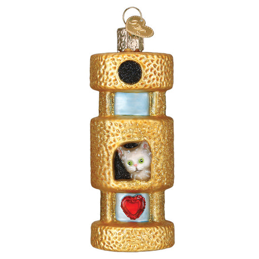 The Cat Tower Ornament from Old World Christmas, model 12633, is a gold textured ornament in the shape of a cylindrical cat tower. It features a small white cat peeking out from a cubbyhole, accented with black and red heart decorations. A metallic loop at the top makes it easy to hang and invites your feline friend to climb and scratch with delight.