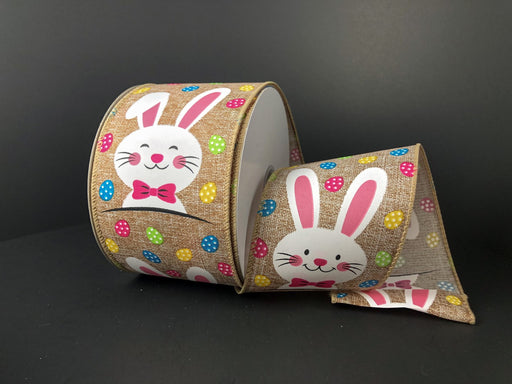 Presenting the 2.5"X10Y Natural Printed Muslin/Happy Bunny, a delightful roll of wired decorative ribbon featuring a bunny with a pink bow tie and colorful polka dots. Set against natural printed muslin, this charming design adds a whimsical touch to any project.