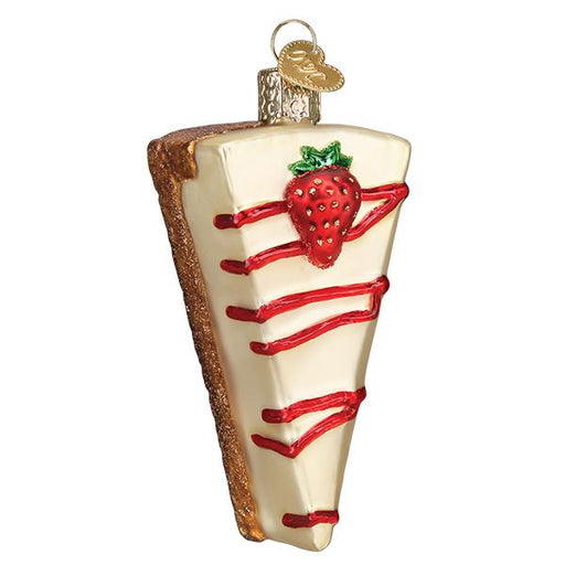 The Cheesecake Old World Christmas Ornament 32429 is a mouth-blown glass piece featuring a strawberry on top and red glaze drizzle, complete with a gold cap for hanging. It beautifully captures the sweet essence of the holidays.