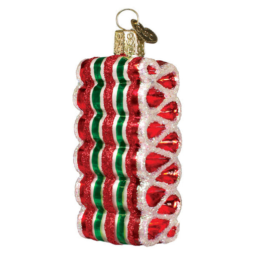 The Christmas Ribbon Candy Ornament by Old World Christmas (36317) is mouth-blown with glitter accents. It boasts wavy red, green, and white edges, a gold cap, and an attached hanging loop, adding festive charm to holiday decor.