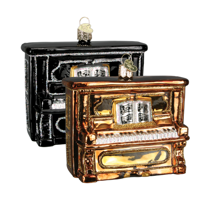 The Upright Piano 38017 Old World Christmas Ornament Assorted collection includes two exquisite upright piano ornaments, one in black and the other in gold. These mouth-blown glass creations boast intricate details, with each piece featuring a music book on the stand and a convenient loop for hanging. Displayed together, these holiday heirlooms exemplify exceptional craftsmanship.