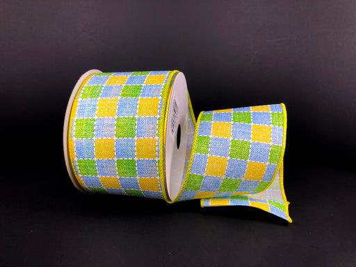 The 2.5X10Y Yellow Blue and Green Plaid Print Linen Ribbon (41327-40-04) is shown on a black background, partially unwound to exhibit its vibrant checkered pattern.