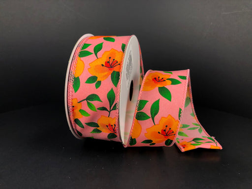 A partially unrolled 1.5X10Y Peach Satin/Orange Magnolias Ribbon (41335-09-23) featuring orange magnolias and green leaves on a dark backdrop beautifully showcases its vibrant floral design.