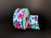 The 1.5X10Y Aqua Satin/Fuchsia Magnolias Ribbon 41335-09-45 features vibrant fuchsia magnolias and blue floral patterns on a dark background, with the wired ribbon elegantly unrolled beside the spool.