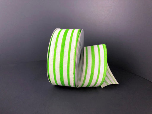 A roll of 1.5X10Y Ivory Green Canvas Stripes 45109-09-09 ribbon is partially unfurled on a dark gray surface, where the vibrant green stripes contrast with the neutral background, adding a lively touch reminiscent of ivory canvas elegance.