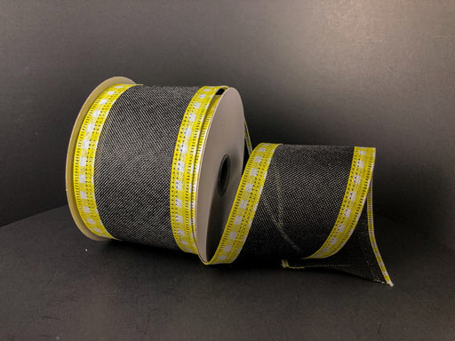 The 2.5X10Y Black Linen/Yellow-White Gingham Edge ribbon (45216-40-49) is elegantly unrolled on a dark surface, with the solid black background accentuating its design.