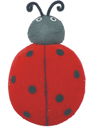 A charming 6 by 9 red ladybug rock with black spots features a gray head, two white eyes, and playful black curly antennas.