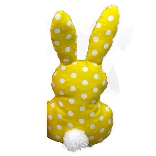 A 12 by 6.5 mixed plush bunny-shaped pillow (63228MIX) featuring white polka dots and a fluffy pom pom tail, displayed on a plain white background.