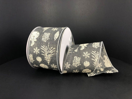 A partially unrolled roll of Grey Canvas/Ivory Stamped Christmas Icons 2.5X10Y ribbon features holiday patterns like snowflakes, ornaments, and trees against a plain black background.