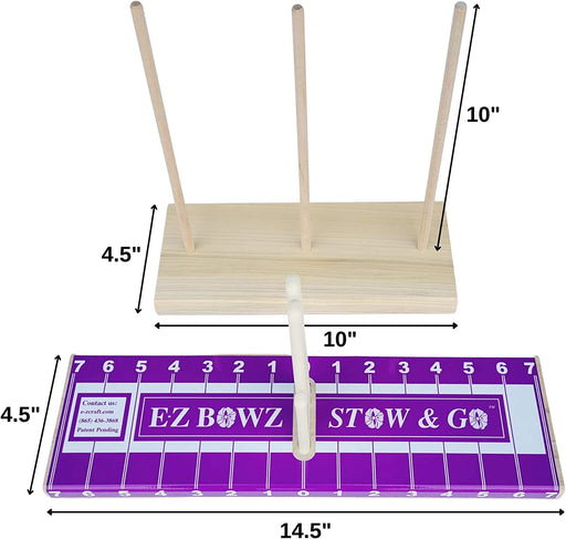 The wooden dowel game has three vertical rods on a 10-inch tall, 4.5-inch wide rectangular base. Next to it is a 14.5-inch ruler with the striking purple and white EZ Bowz Stow & Go design, ideal for any bow makers toolkit.