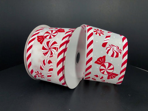 Two rolls of White Satin Peppermints/Candy Cane Edge 2.5"X10Y Ribbon (75108-40-13) are placed side by side against a black background, showcasing white satin adorned with red peppermint candy and candy cane patterns.