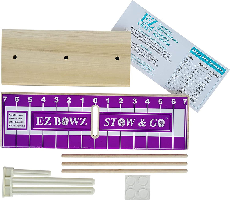 The EZ Bowz Stow & Go Bow Maker set includes a wooden measuring board with purple markings, three wooden dowels, four white adhesive pads, and an instruction sheet. The board features numerical guides from 1 to 7 for crafting perfect bows anywhere you need.