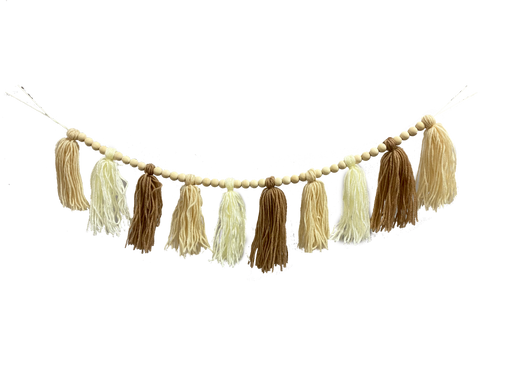 Product 85622CMBN: A 4-foot Cream and Brown Yarn Tassel Bead Garland features alternating beige and brown tassels, strung with small wooden beads, evenly spaced to give a festive rustic look against a black background.