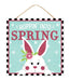 The 10Sq Hoppin Into Spring/Bunny Glitter sign (AP8992) features a cute white bunny with a pink flower against a teal polka-dot background. Hoppin Into Spring sparkles in pink glittery letters, and its hung by a sturdy rope for charming MDF spring decor.