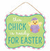 The 10.5L x 9H Easter Glitter Sign features a green MDF background with This chick is ready for Easter in sparkly text. A cute chick emerges from a purple polka-dotted egg, and a pink and white striped border adds charm. Perfect with its hanging rope for festive decor!.
