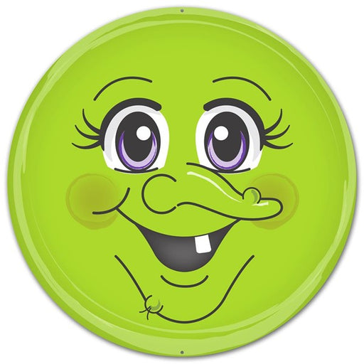 A cheerful, bright green cartoon face with big purple eyes, long lashes, rosy cheeks, and a toothy grin makes the 12 Round Metal Green Witch Face Halloween Sign (MD0326) a quirky, charming décor piece for any space.