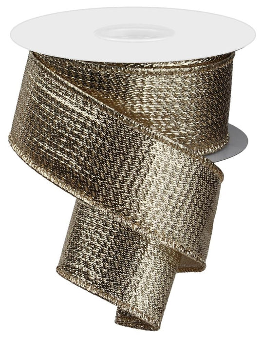 A 1.5" x 10 yd spool of champagne gold metallic ribbon (RG0139944) with a wired edge, textured shiny surface, is partially unrolled and spirals downward against a white background.