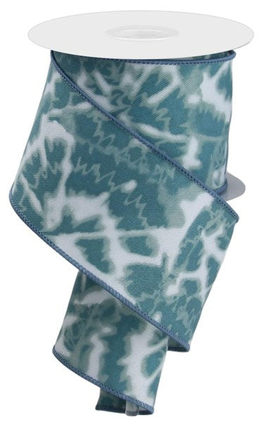The 2.5X10Yd Soft Tie Dye On Diagonal White/Smoke Blue (RGE1241H5) ribbon features a blue and white tie dye pattern, partially unrolled and draped in a loose spiral.