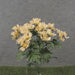 The 19 Cosmos Bush (SE2503-BEI) features 12 beige stems with light peach flowers, yellow centers, and green leaves. Set against a gray background, the dark green base mimics grass for a natural elegance.