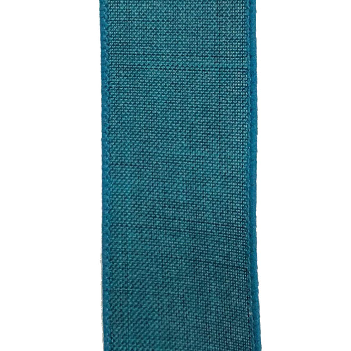 A close-up of the 2.5 Turquoise Canvas Ribbon X314840-39 reveals its textured woven fibers, slightly rough finish, and neatly sewn edges. Vertically aligned against a plain white background, this wired ribbon showcases a structured yet elegant appeal.