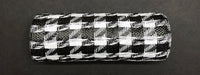 The Houndstooth Black-White Woven Mesh, model XB108910-01, features a bold houndstooth pattern as it lays horizontally on a dark background, highlighting its textured checkered design.